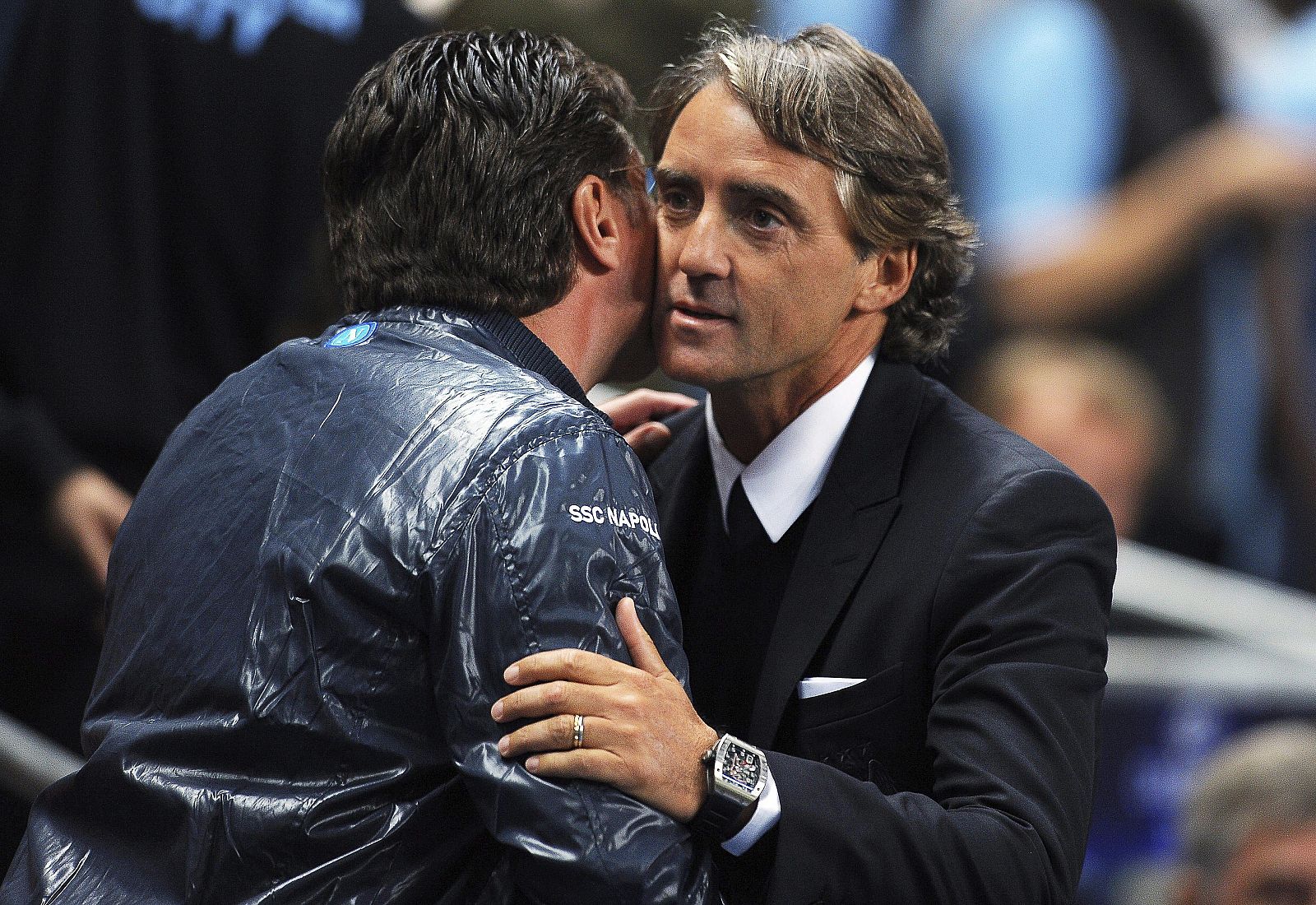 Fotografía de archivo fechada el 14 de septiembre de 2011, del entonces entrenador del Nápoles, Walter Mazzarri (i), mientras saluda al entonces técnico del Manchester City, Roberto Mancini.