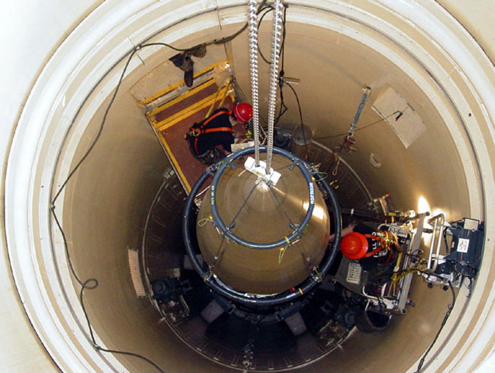 File photo of a US Air Force missile maintenance team removing the upper section of an intercontinental ballistic missile with a nuclear warhead