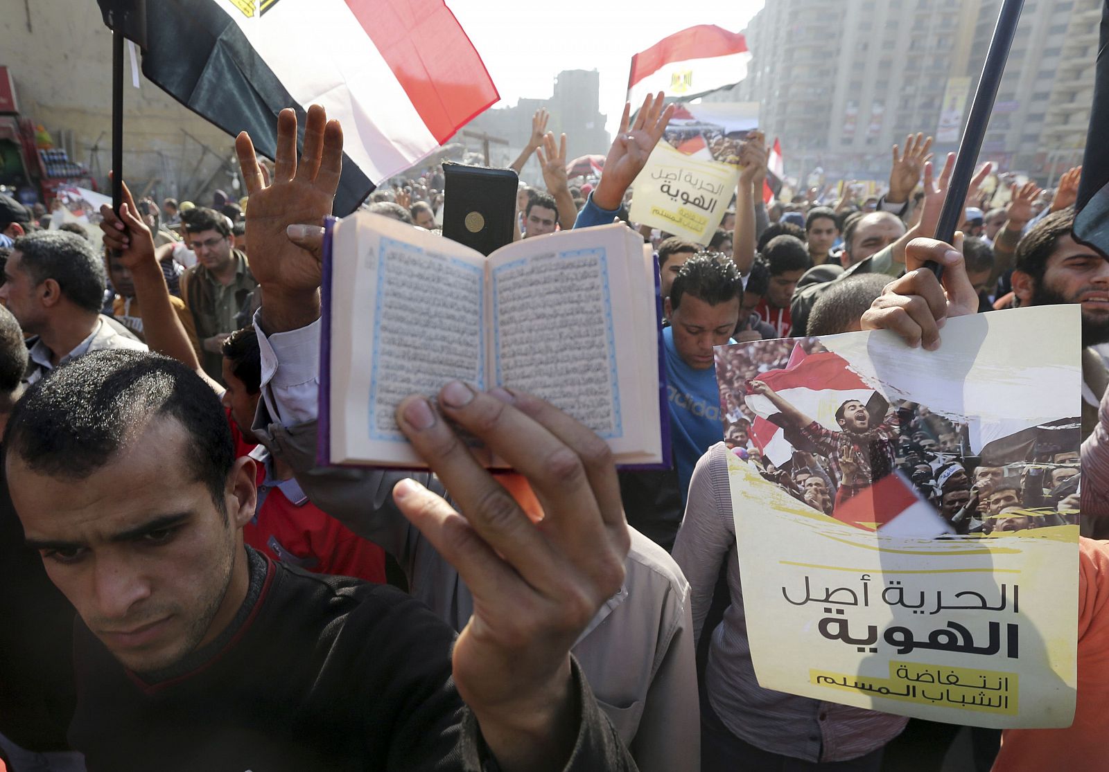 Supporters of the Muslim Brotherhood and ousted Egyptian President Mohamed Mursi shout slogans against he military and interior ministry and rise copies of the Koran t, during a protest in the Cairo suburb of Matariya