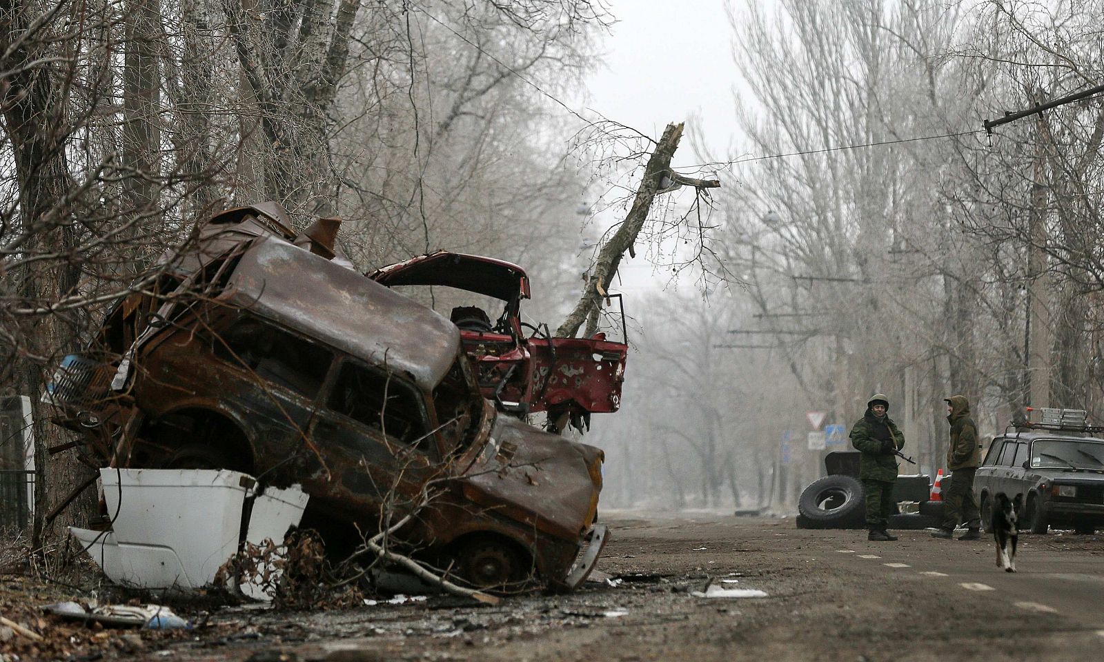 Pro-Russian separatists stand guard next to cars damaged during fighting between pro-Russian rebels and Ukrainian government forces near Donetsk Sergey Prokofiev International Airport, eastern Ukraine