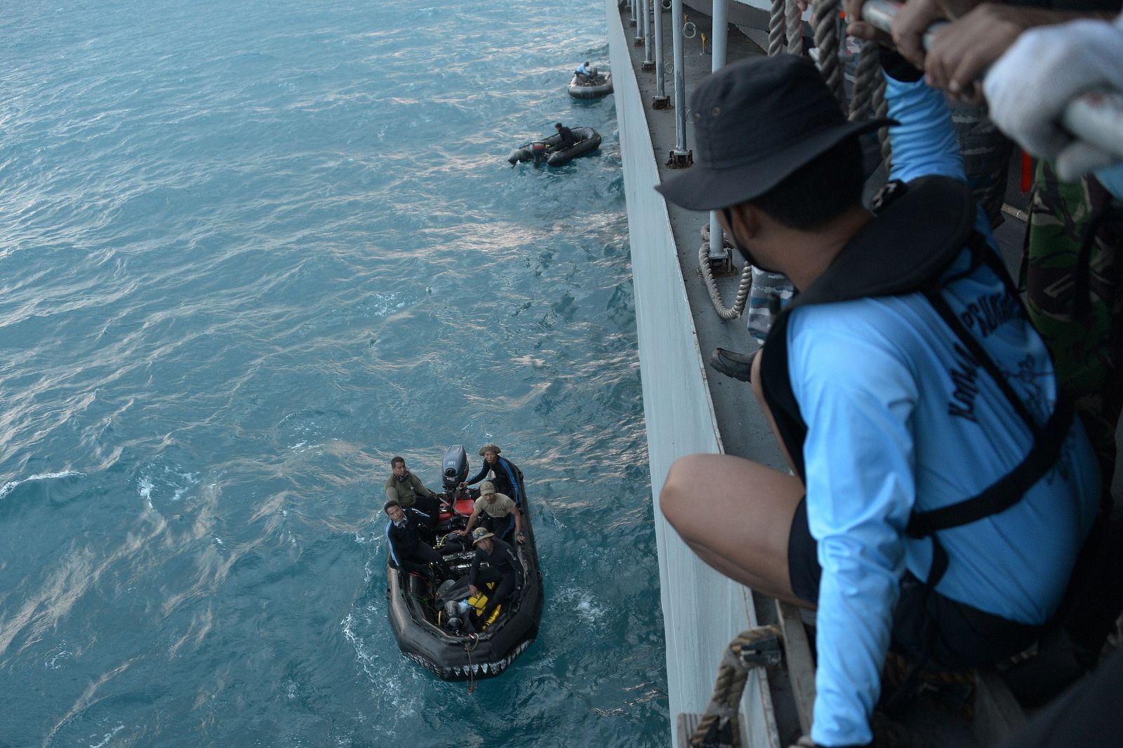 Buzos de la Marina indonesia se preparan para sumergirse en una operación para llegar a los restos de la cola del vuelo QZ8501.