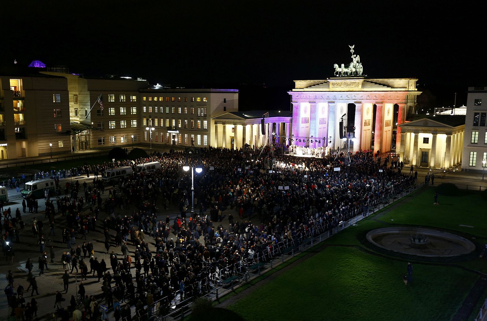 People gather in front of the Brandenburg Gate at Pariser Platz during vigil for the victims of Paris attacks in Berlin