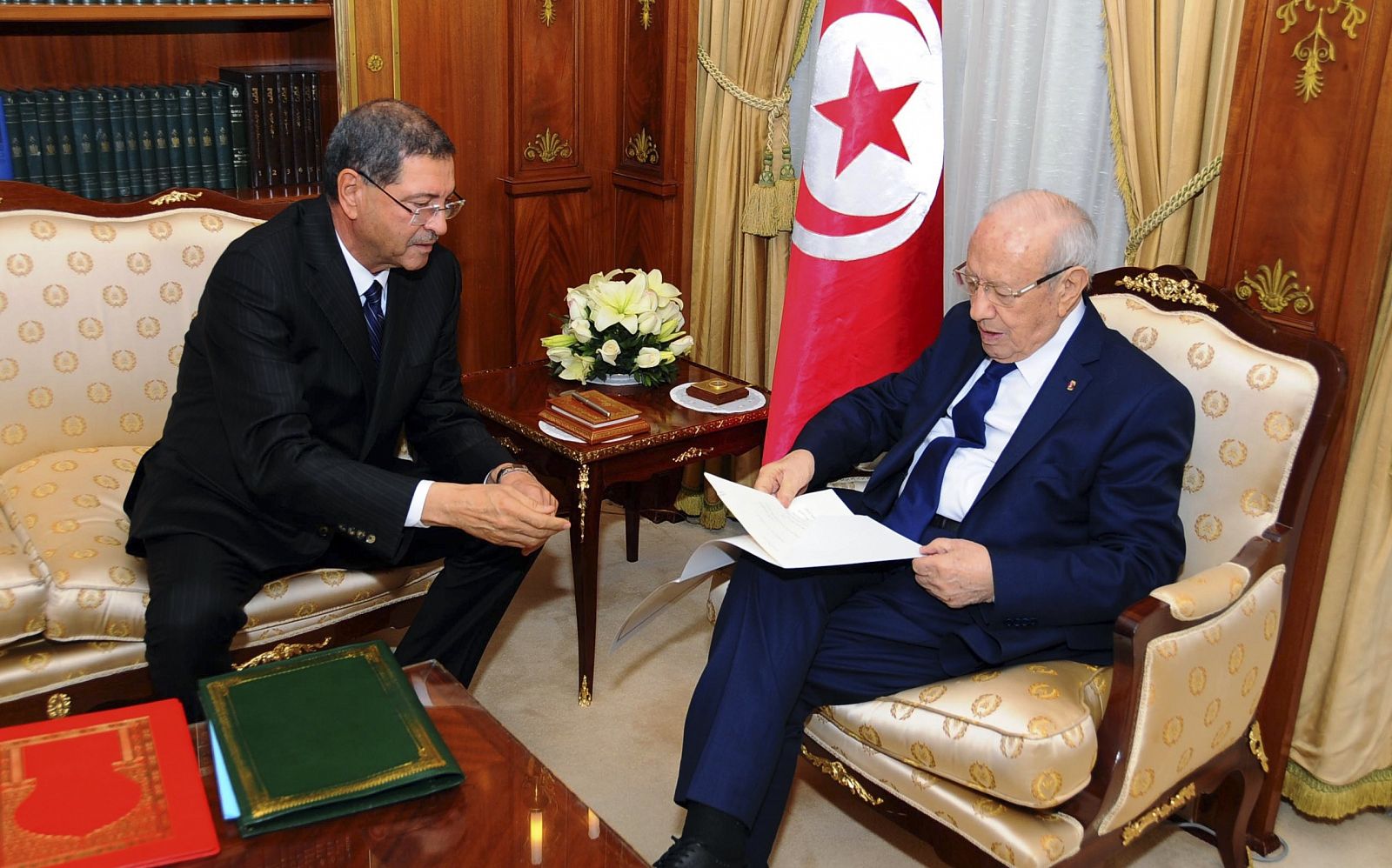 Tunisia's nominated prime minister Habib Essid gives the list of the new government to President Beji Caid Essebsi in Tunis