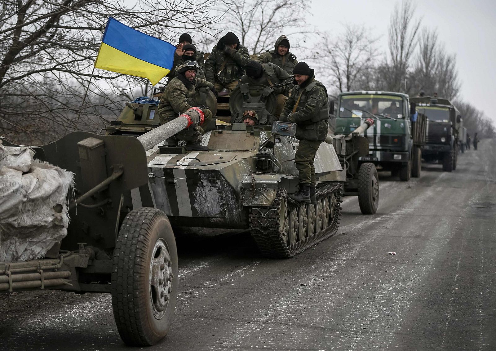 A convoy of Ukrainian armed forces including armoured personnel carriers, military vehicles and cannons prepare to move as they pull back from Debaltseve region, in Paraskoviyvka