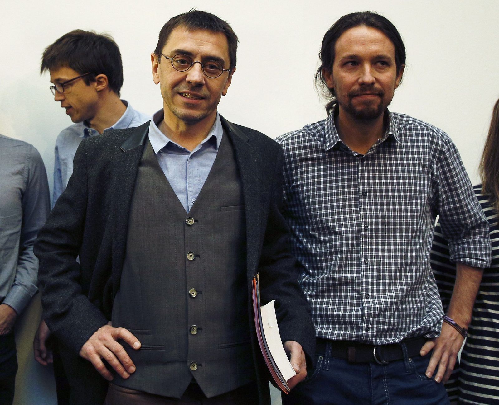 Monedero stands next to Iglesias before a news conference in Madrid