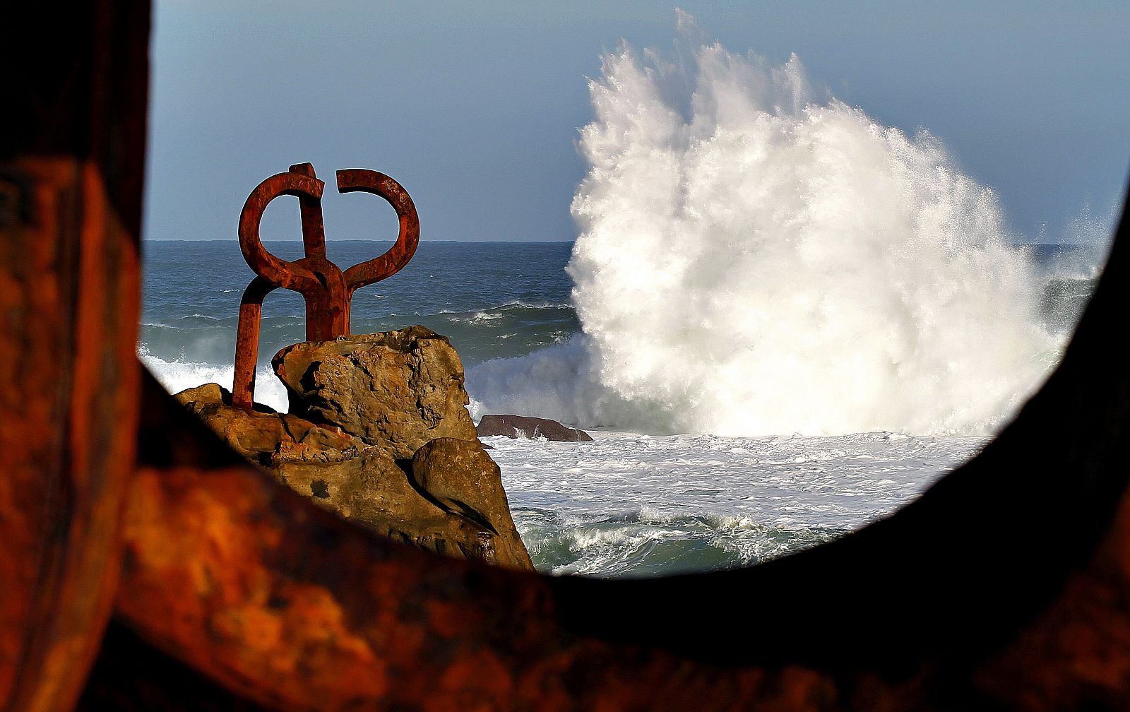 Una ola rompe junto al Peine de Viento, Obra de Eduardo Chillida, en San Sebastián.