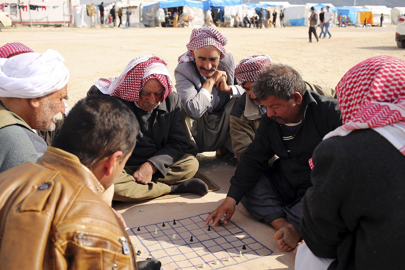 Yazidi refugees play chess at Sharya refugee camp on the outskirts of Duhok