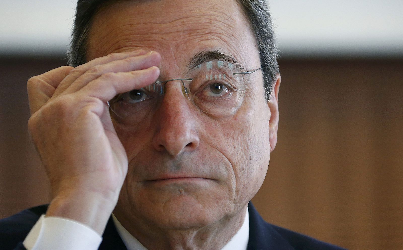 European Central Bank (ECB) President Draghi adjusts his glasses during the IMFS Conference 2015 in Frankfurt