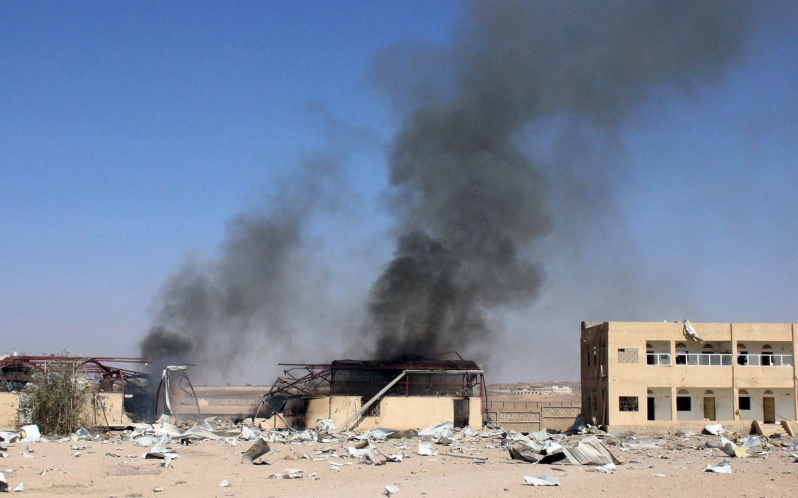 Smoke rises from a military supply post after it was hit by an air strike in Yemen's northwestern city of Saada