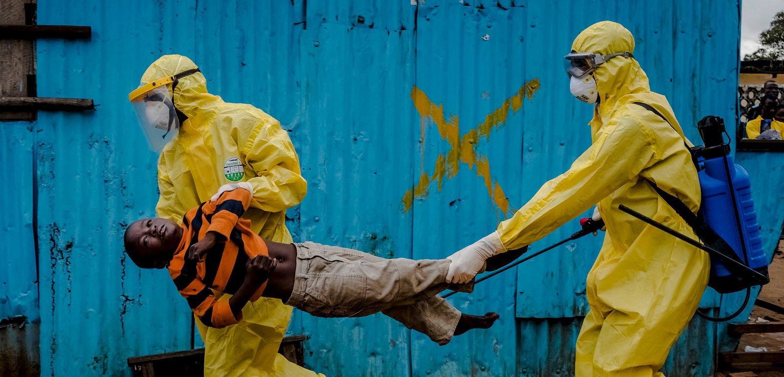 Medical staff carry James Dorbor, 8, suspected of having Ebola, into a treatment facility in Monrovia, Liberia.
