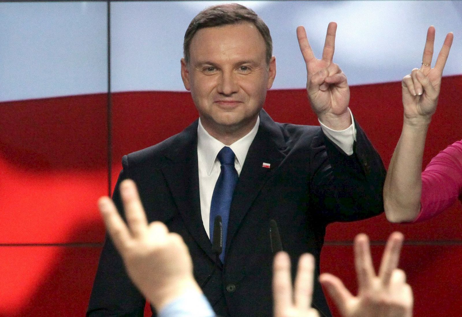 Duda candidate of Law and Justice party shows victory sign after announcement of first exit polls in first round of Polish presidential elections in Warsaw