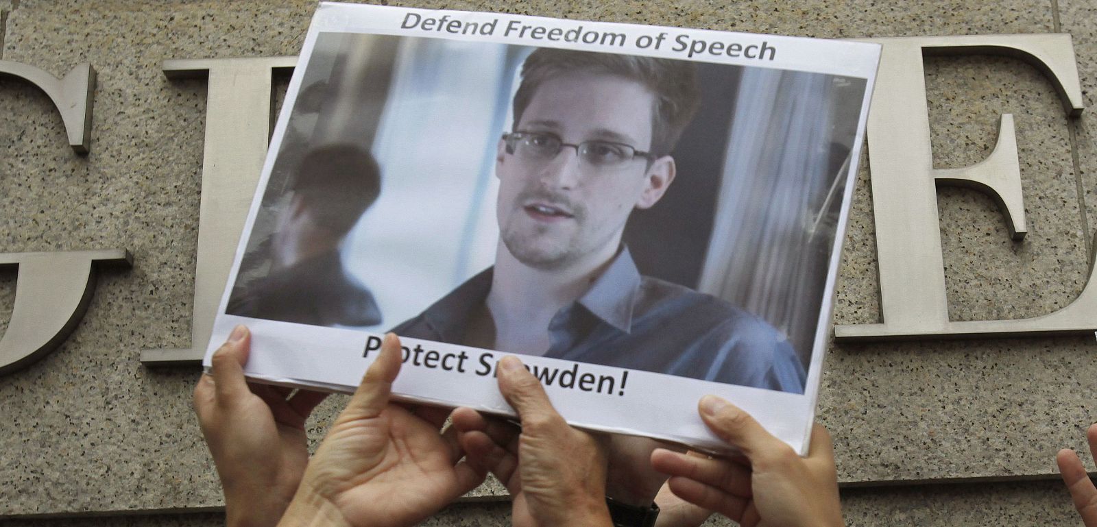 File photo of protesters supporting Snowden hold a photo of him during a demonstration outside the U.S. Consulate in Hong Kong