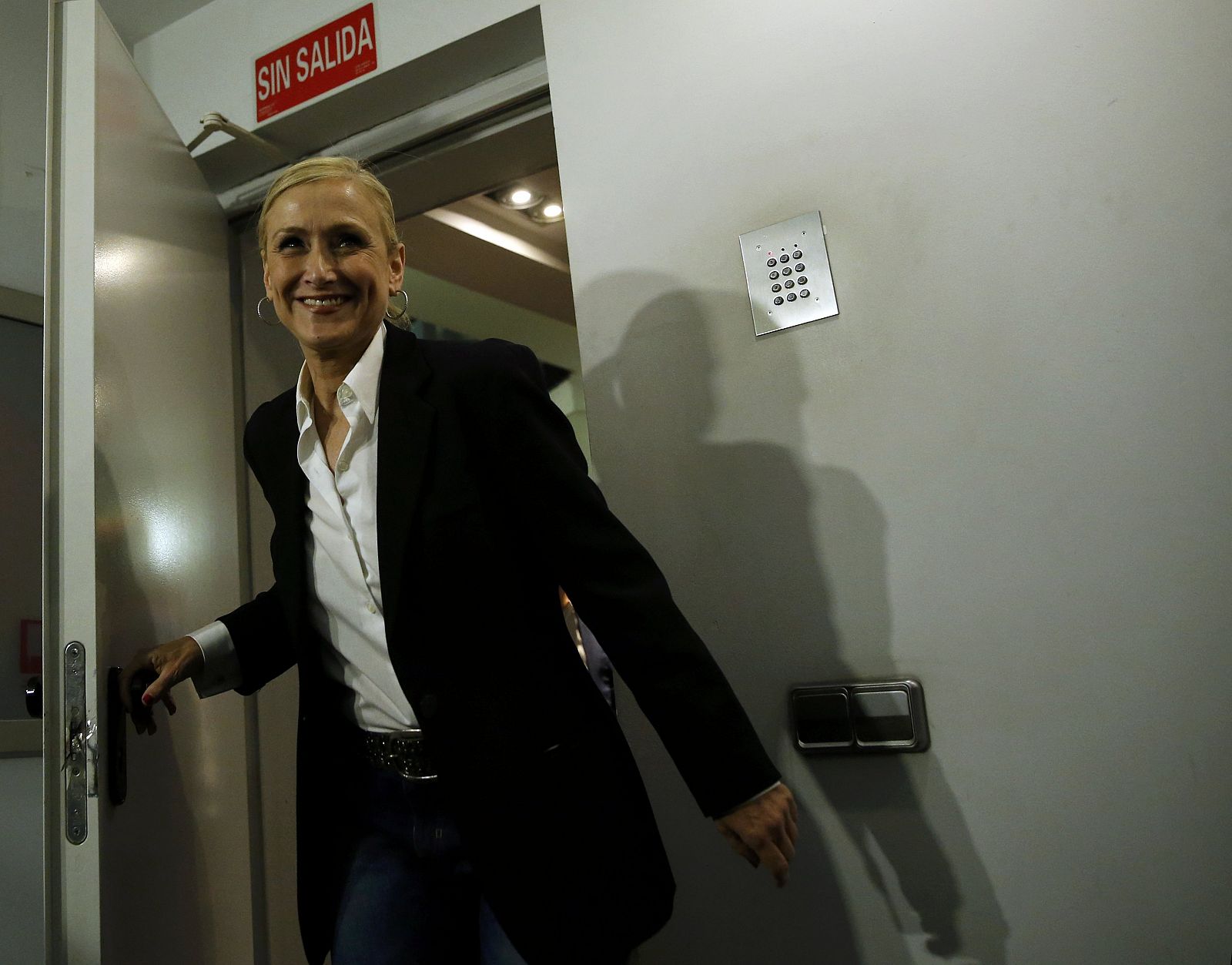 Cifuentes, Madrid's regional candidate of ruling People's Party (PP), smiles as she enters at press room inside PP headquarters after the regional and municipal elections in Madrid