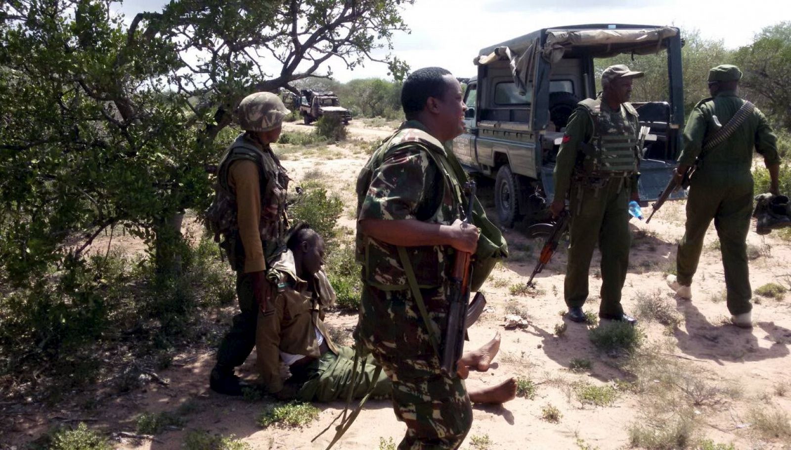 An injured Administration police officer is helped by his colleagues after they were ambushed by Somalia's al Shabaab fighters in Yumbis village near the Kenya-Somalia border