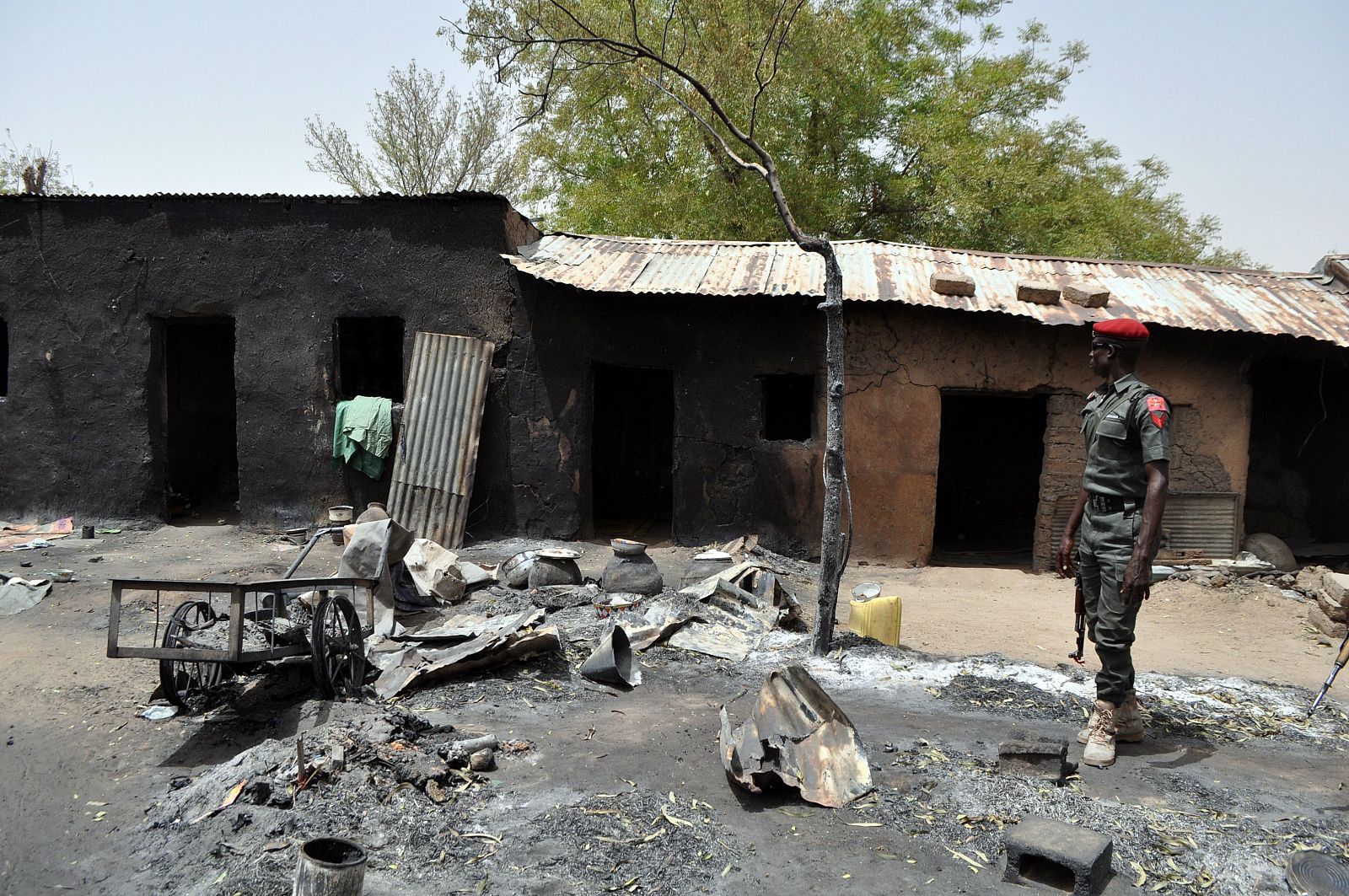 Un policía observa una casa en Gubio, estado de Borno, Nigeria, tras un ataque de Boko Haram