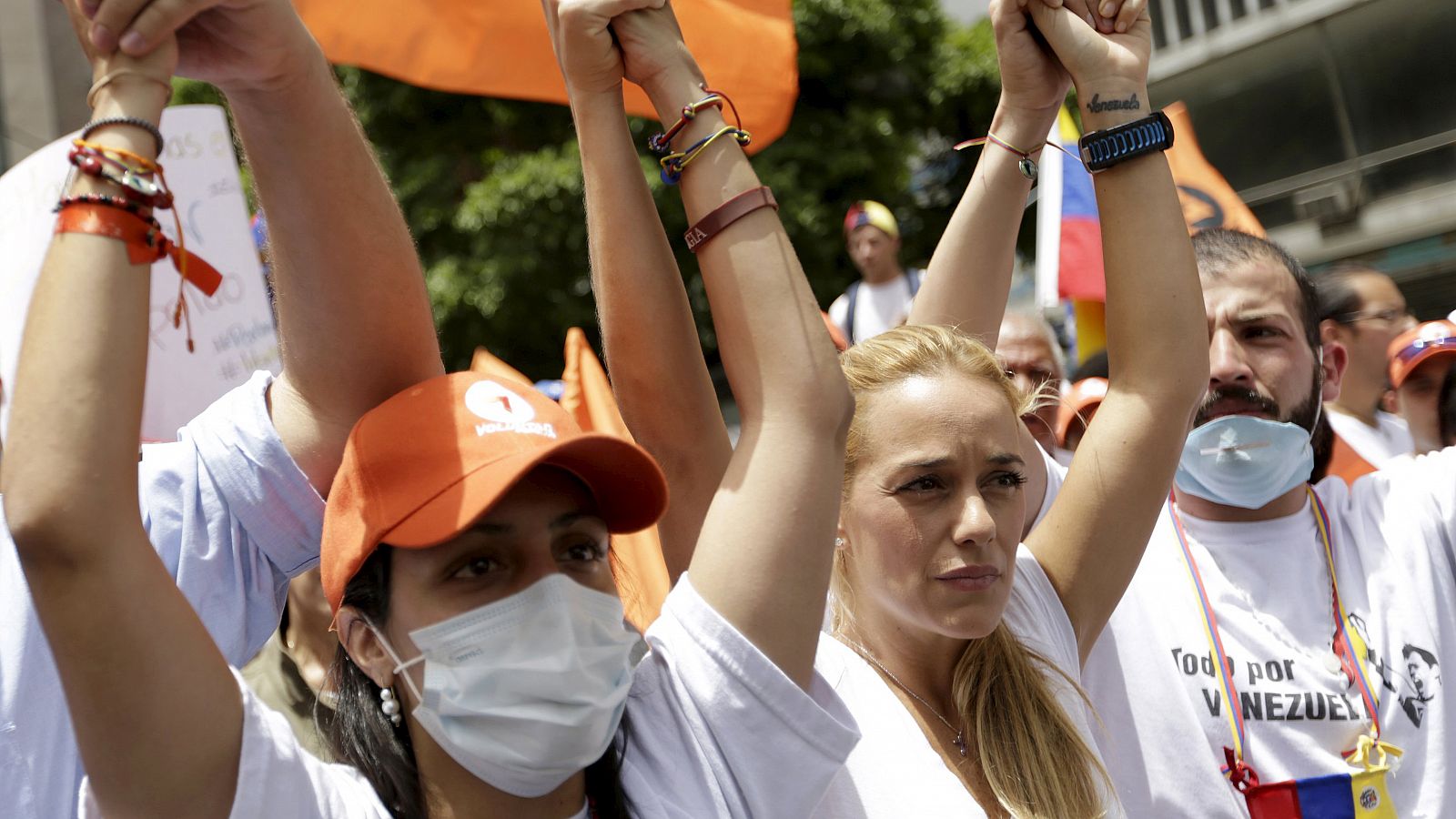 Lilian Tintori, wife of opposition leader Leopoldo Lopez, puts her hands up with opposition supporters on hunger strike in a demonstration in Caracas