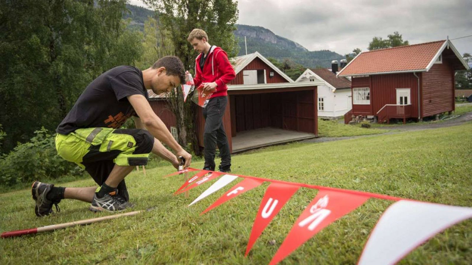 Activistas colocan banderas del Partido Laborista noruega (UAF) en Utoya, en los preparativos de la reapertura del campamento