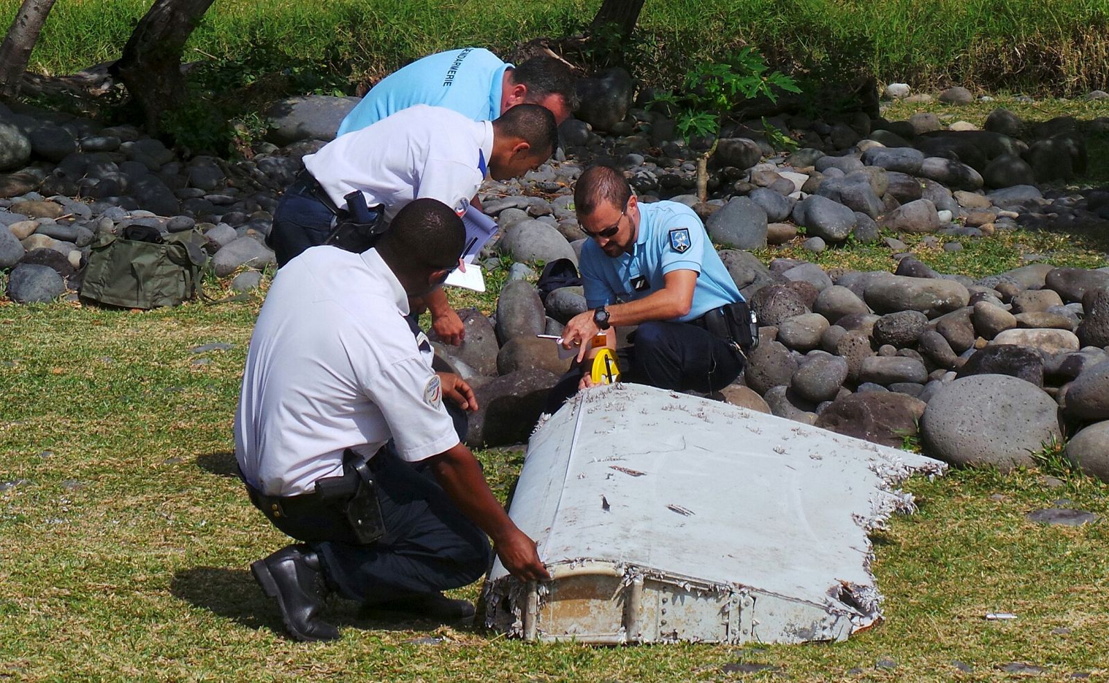 Gendarmes franceses inspeccionan los restos del Boeing 777 en La Reunión.