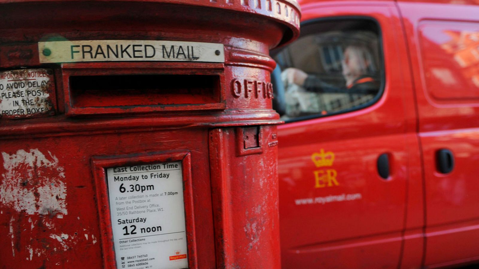 Un trabajador del Royal Mail aparca delante de un buzón en Londres