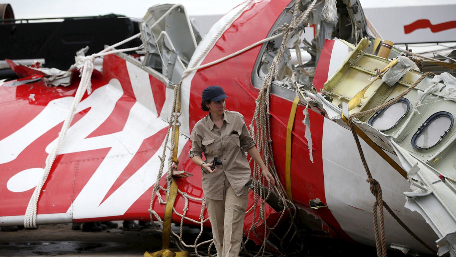 Una investigadora de Airbus camina junto a los restos del avión de Air Asia accidentado