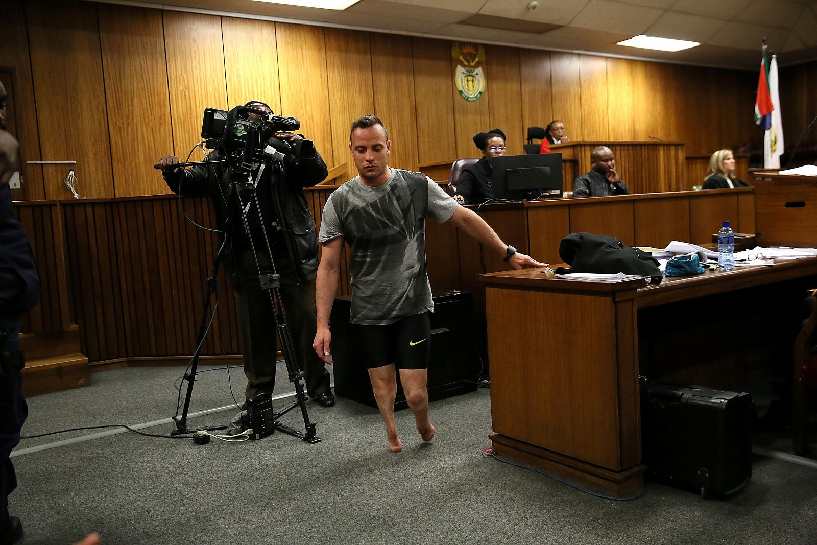 Paralympic gold medalist Oscar Pistorius walks across the courtroom without his prosthetic legs during the third day of his resentencing hearing for the 2013 murder of his girlfriend Reeva Steenkamp