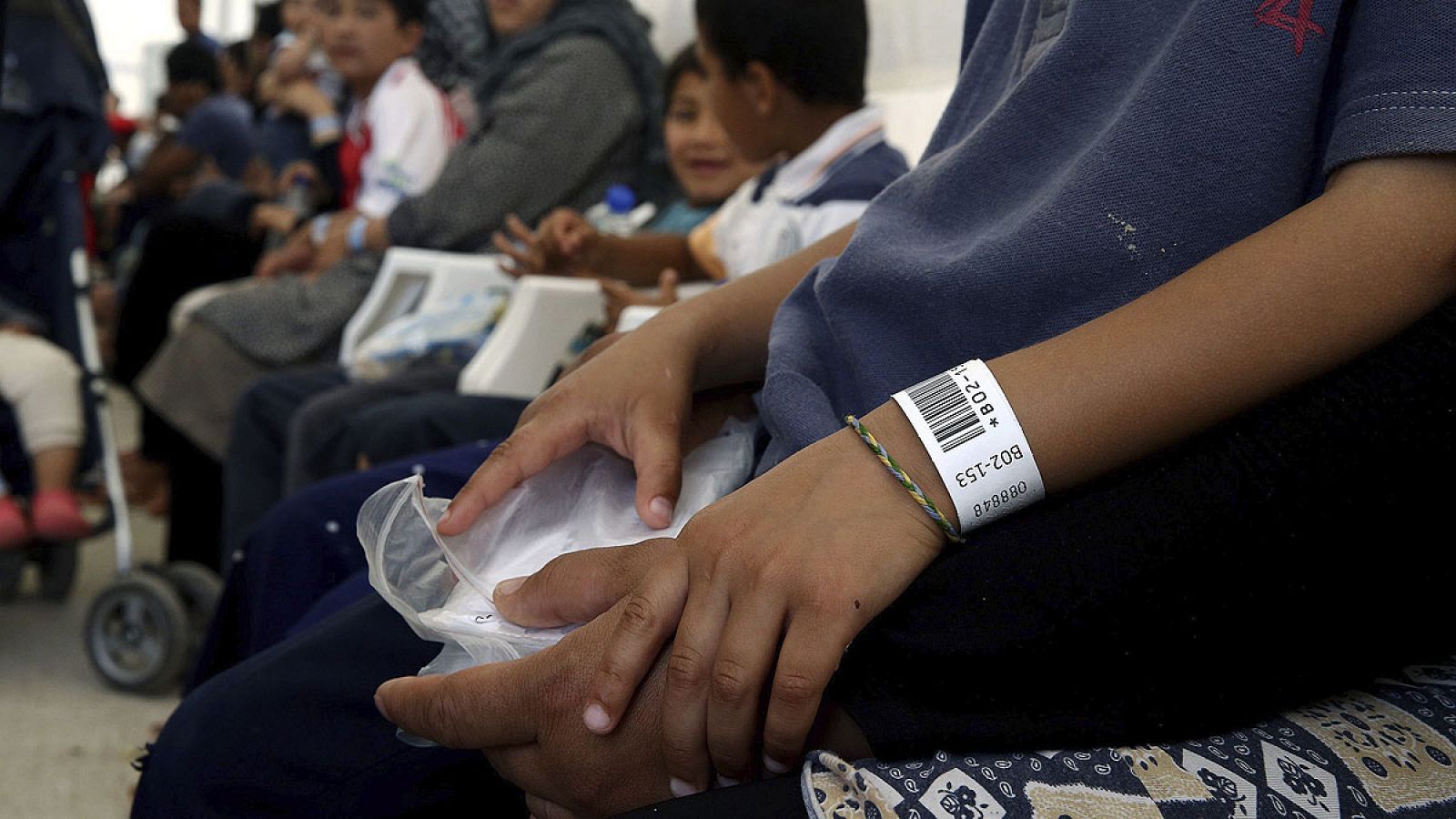 Refugiados y migrantes esperan para el proceso de pre-registro en un campamento de refugiados en el antiguo aeropuerto de Helliniko de Atenas