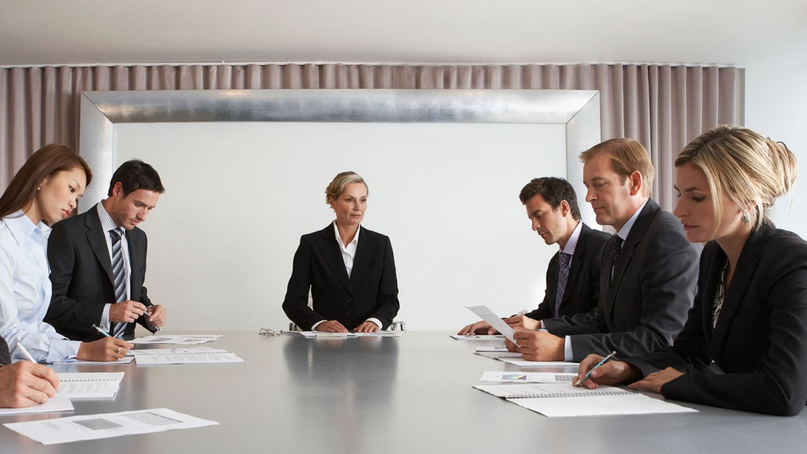 Una alta ejecutiva dirige una reunión en una empresa