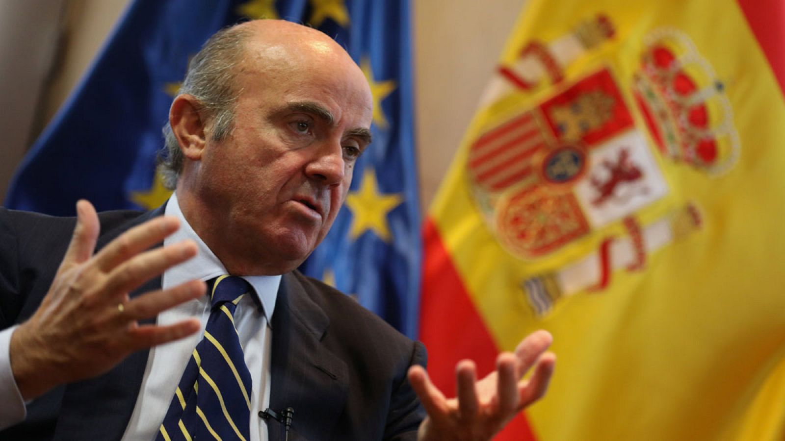 Spain's Economy Minister de Guindos gestures during an interview with Reuters at Economy Ministry in Madrid
