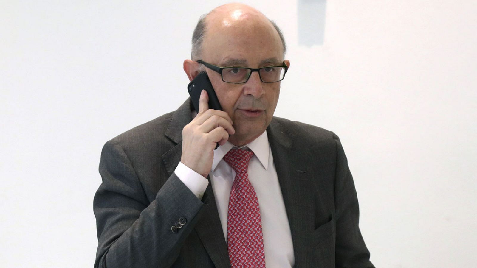 El ministro de Hacienda habla por el móvil