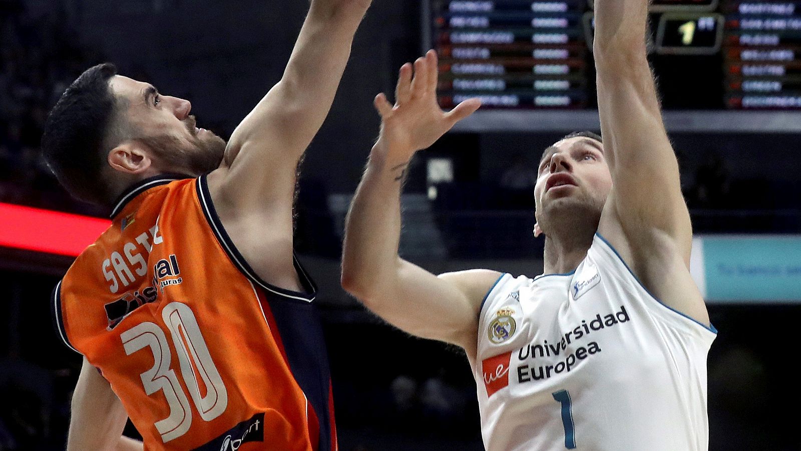 El alero del Valencia Basket Joan Sastre (i) tapona al escolta del Real Madrid Fabien Causeur.