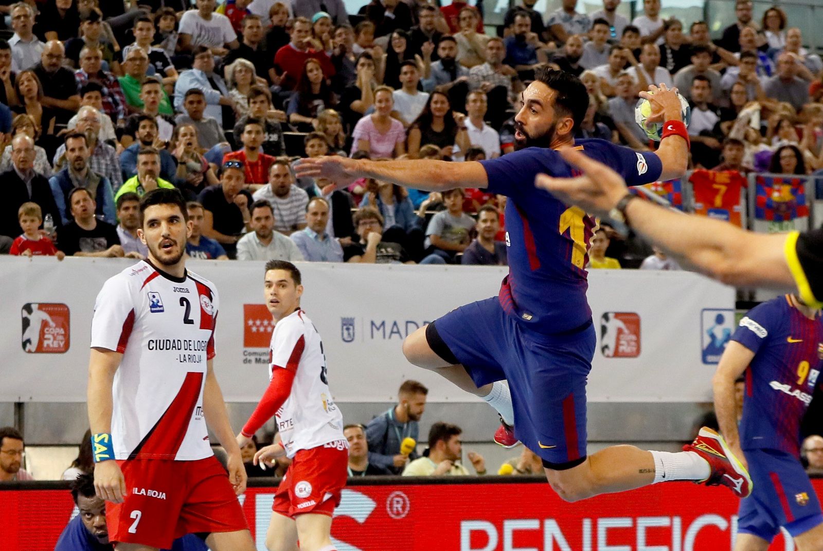 El extremo izquierdo del Barcelona Lassa Valero Rivera (d) lanza ante dos rivales del Logroño La Rioja en la final de la Copa del Rey de Balonmano.