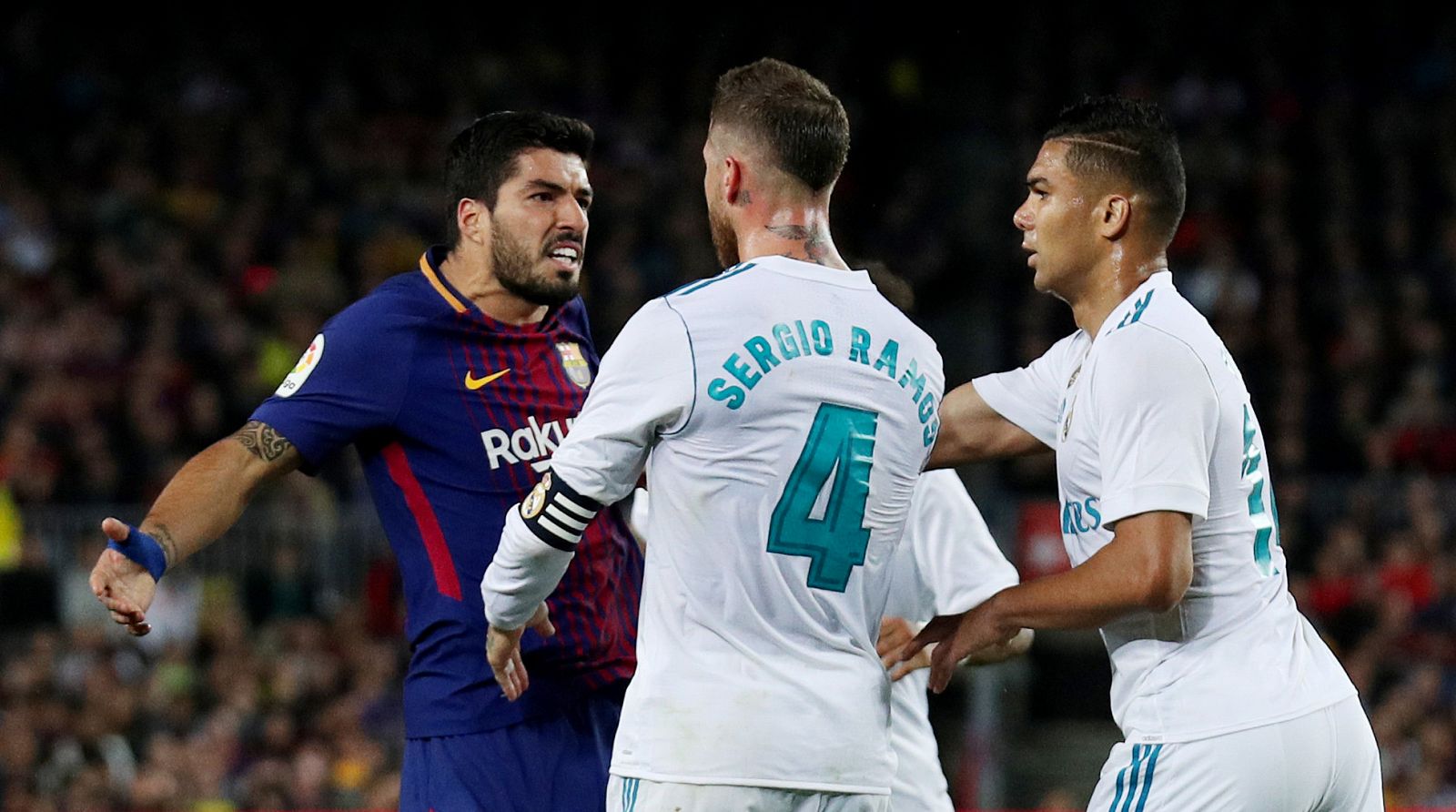 Sergio Ramos y Luis Suárez se enfrentan durante un lance del clásico.