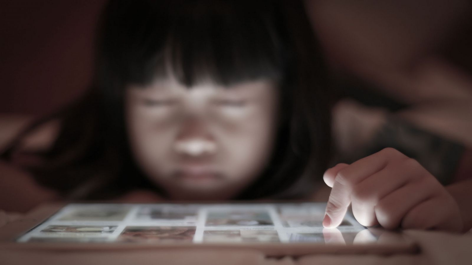 Una niña ve contenidos de internet en una tablet