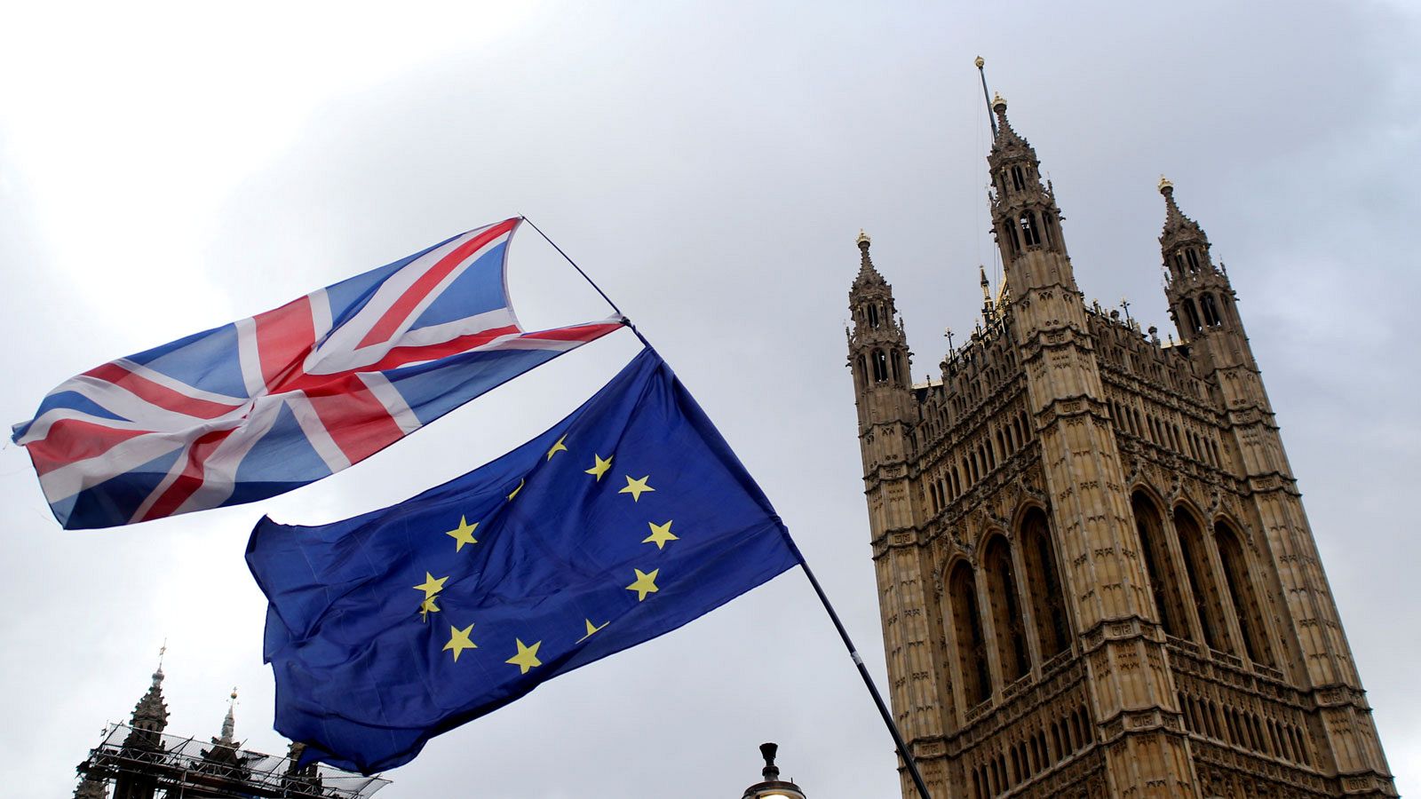 Una bandera británica y otra de la UE ondean frente al Parlamento británico