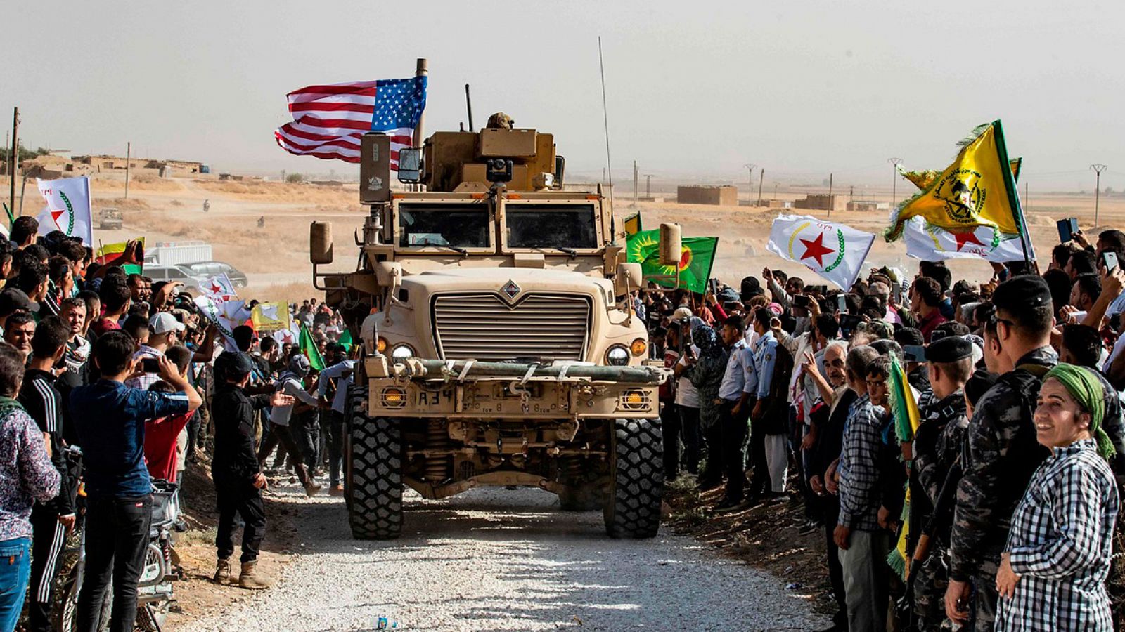 Manifestantes kurdos rodean un vehículo de las tropas de EE.UU. en Ras al Ain en la provincia de Hasaka, noreste de Siria. Delil SOULEIMAN / AFP