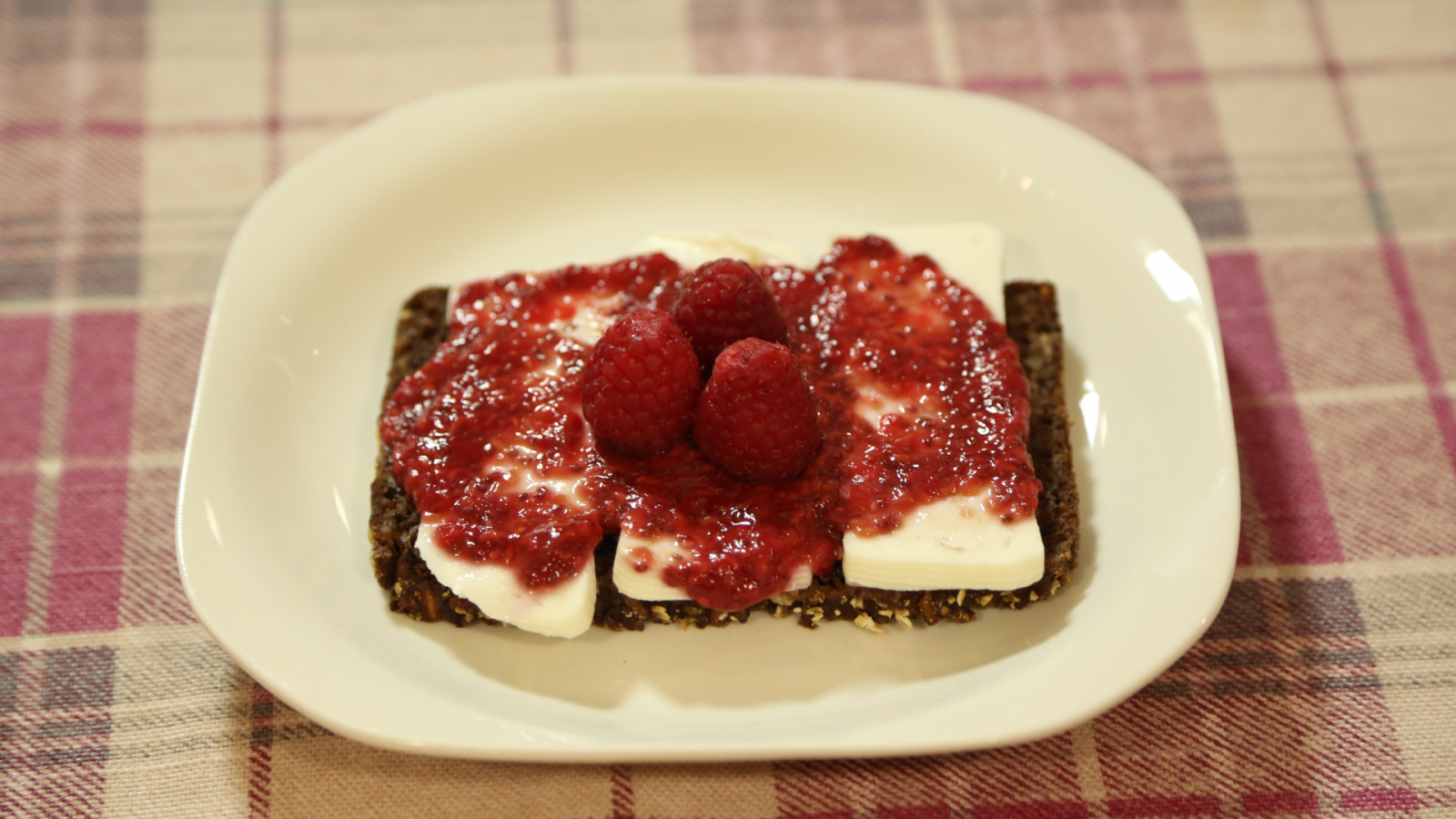 Tostadas integrales con queso fresco y mermelada saludable de frambuesa