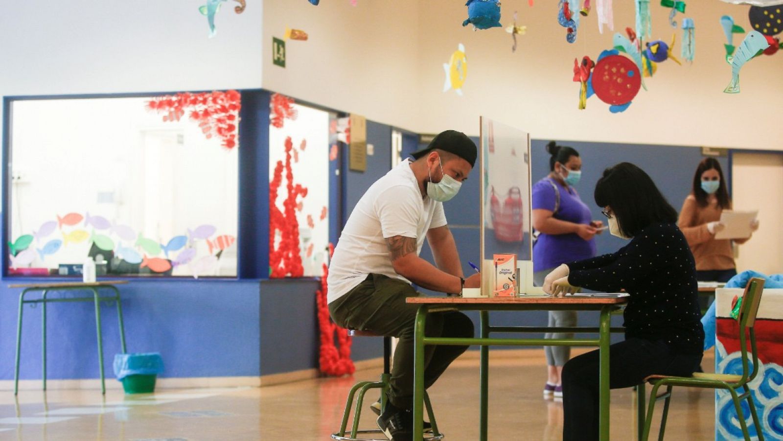 Una administrativa de la Escola l'Estel de Barcelona atiende a una persona.