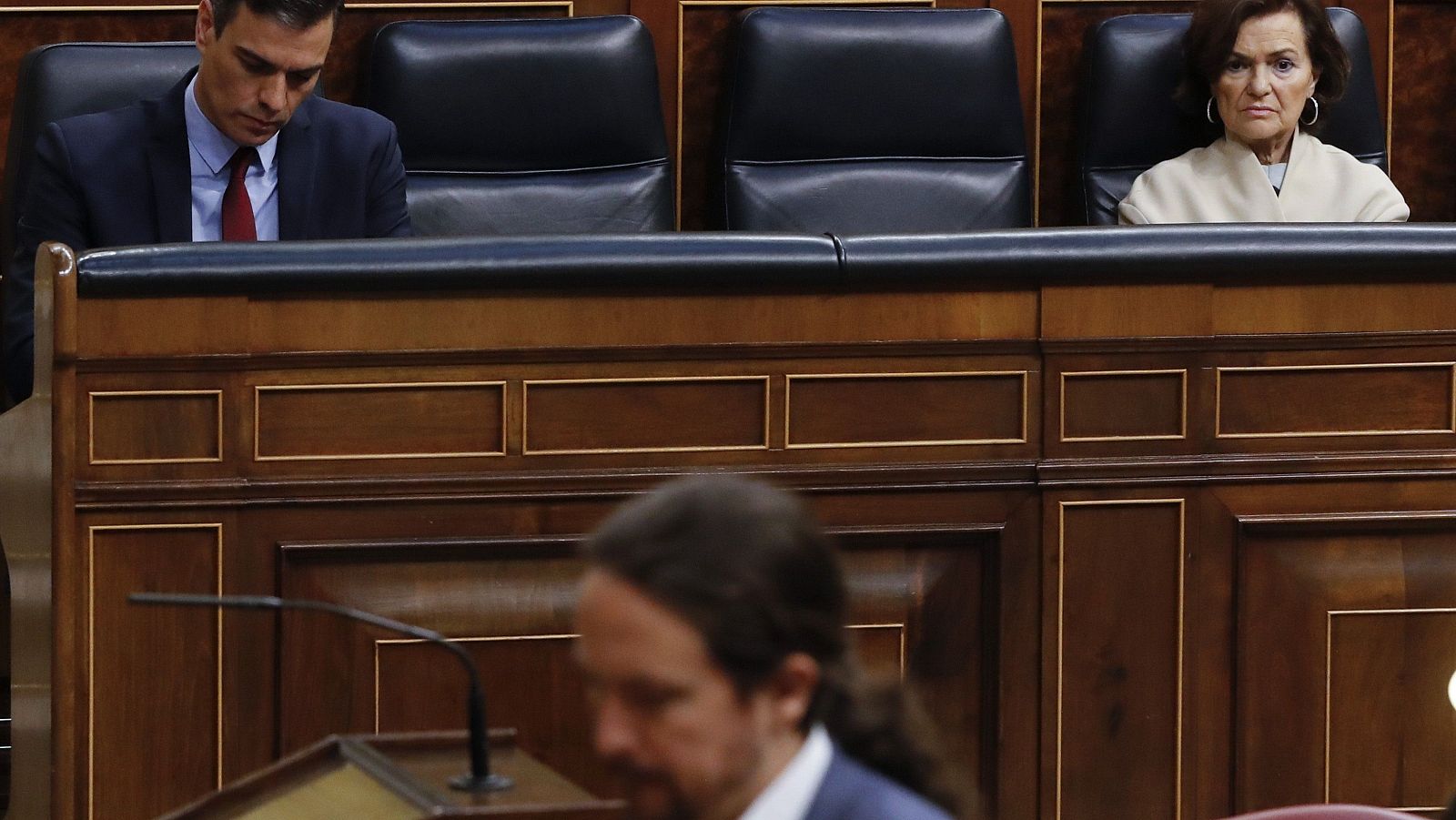 Pablo Iglesias pasa ante Pedro Sánchez y Carmen Calvo durante el debate del estado de alarma en el Congreso.