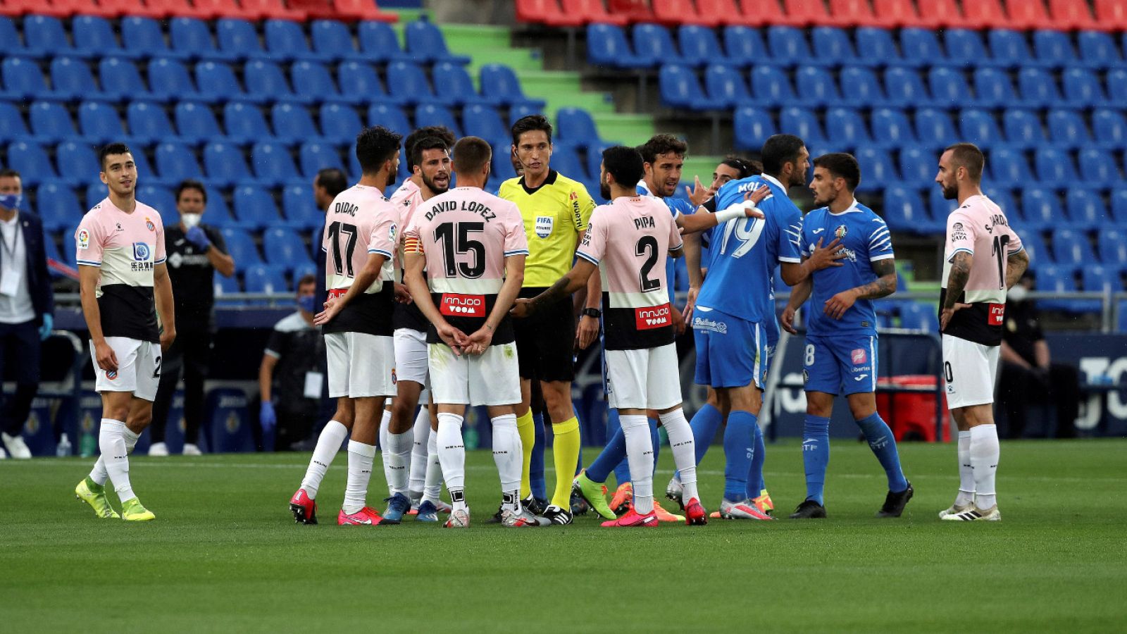 Jugadores del Getafe y el Espanyol rodean al árbitro