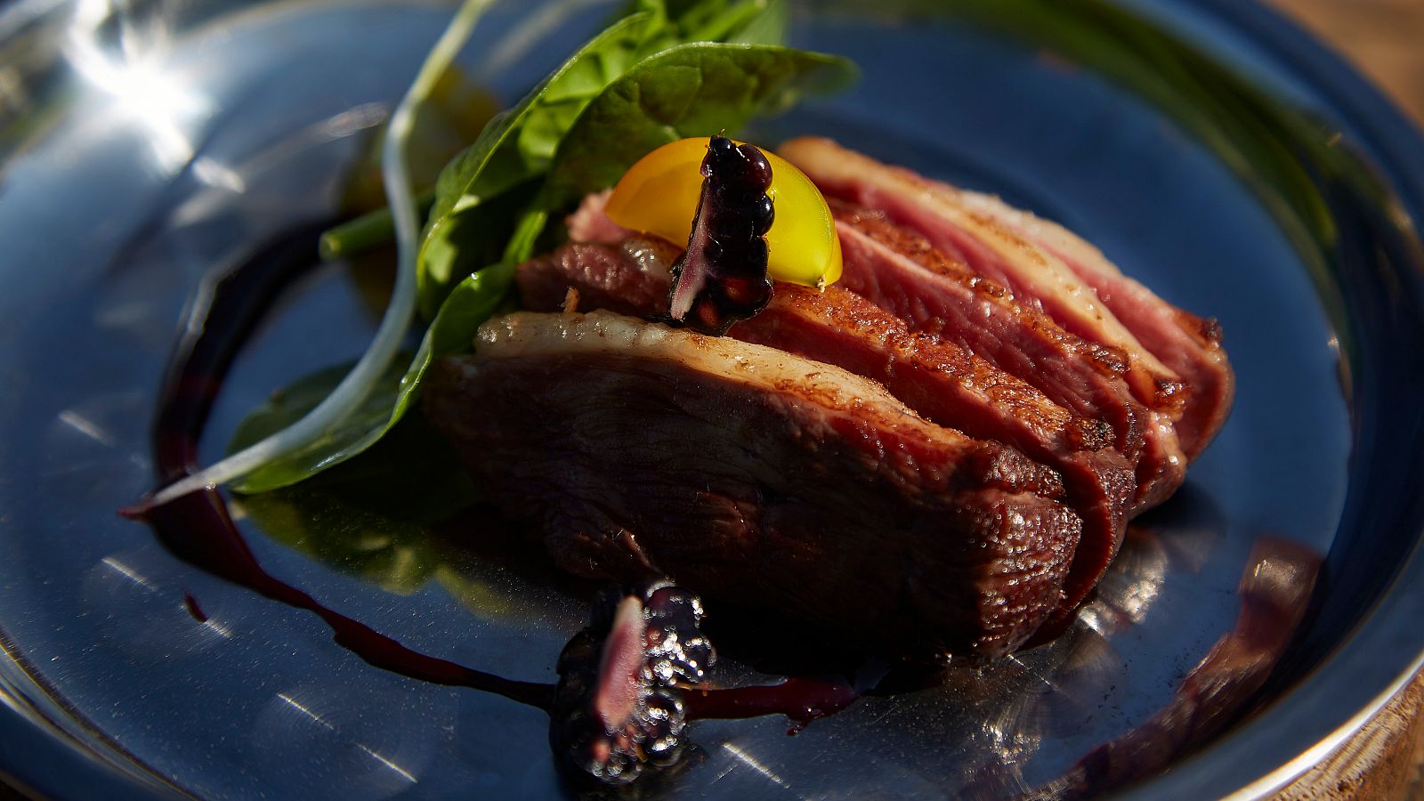 Magret de pato con compotas de moras y ensalada de espinaca roja