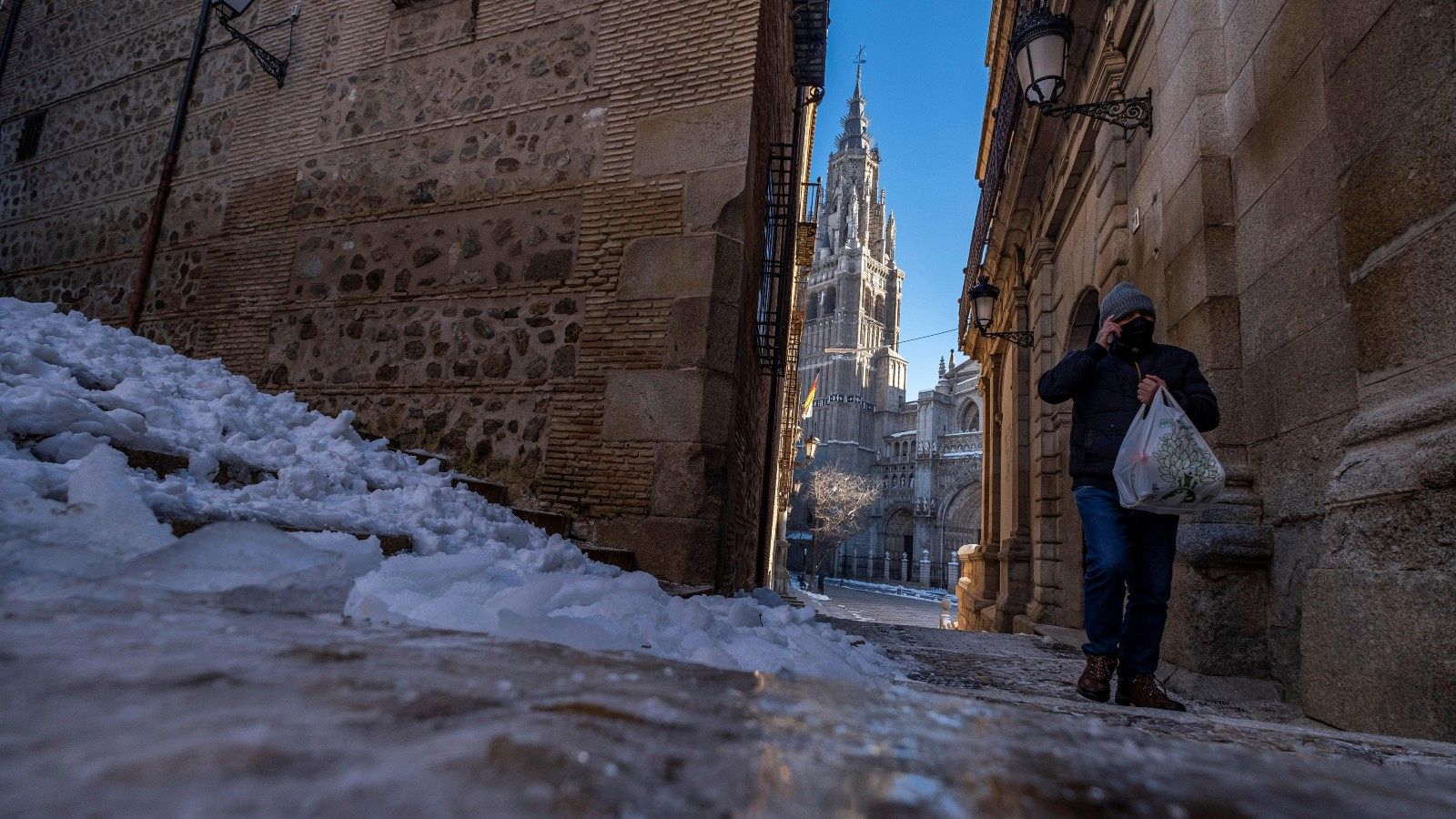 Un hombre camina junto al hielo formado en las calles de Toledo donde este martes se han registrado -10 grados bajo cero