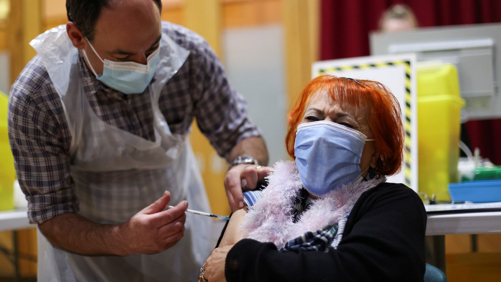 Una mujer recibe una vacuna contra la COVID-19 en Reino Unido