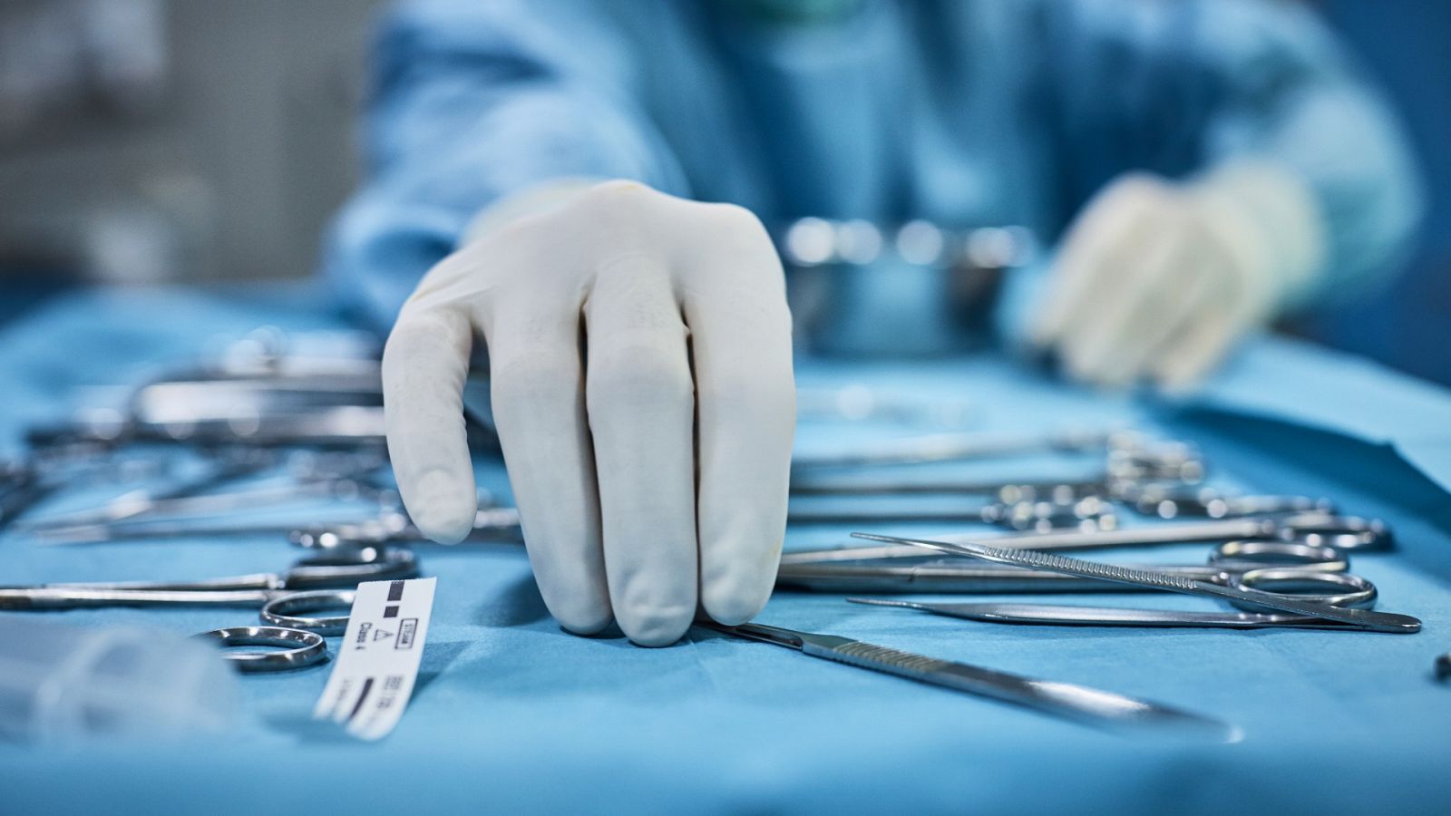 Un cirujano escoge una herramienta quirúrgica