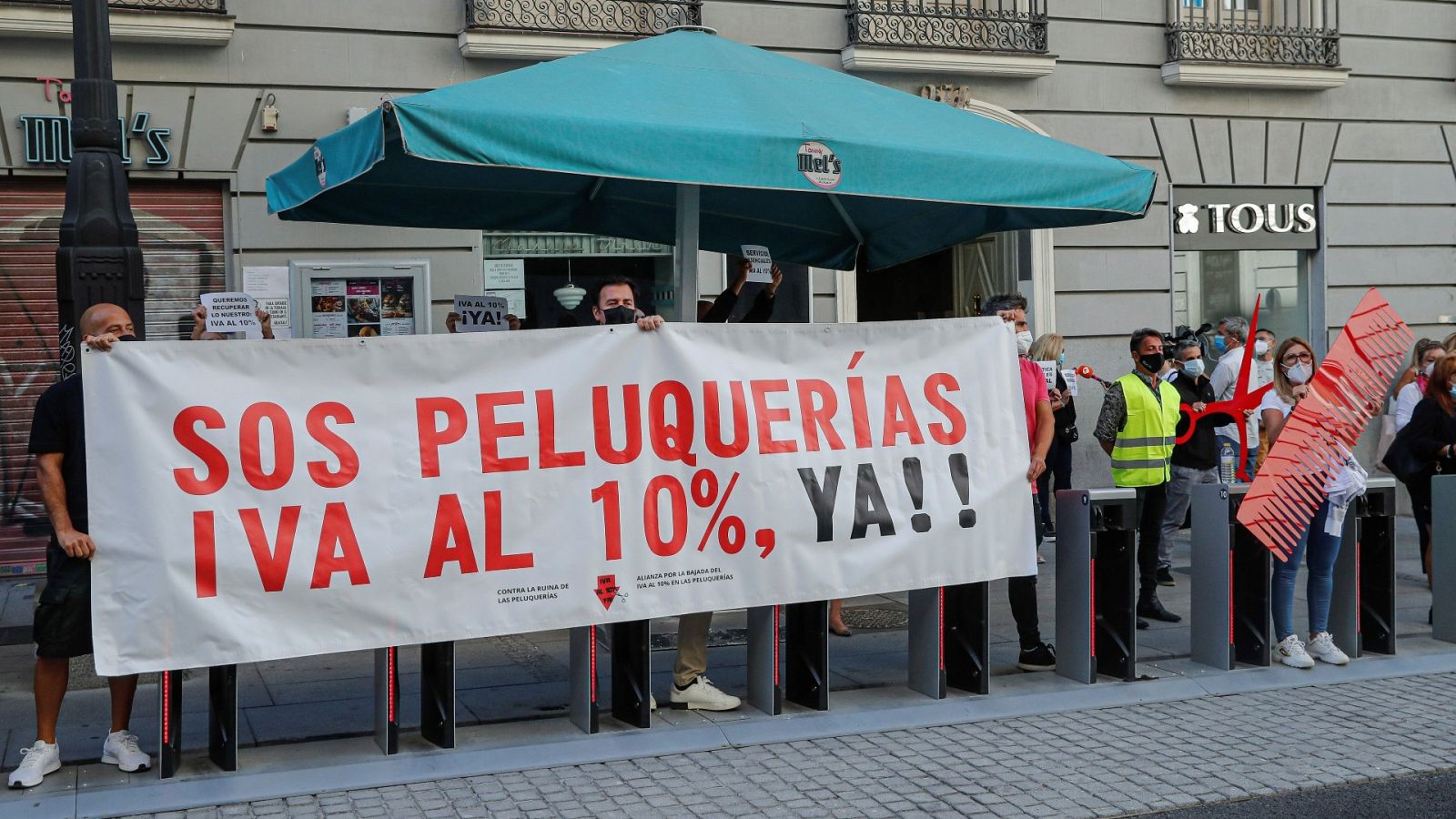 Manifestantes convocados por la Alianza por la Bajada del IVA al 10% a las Peluquerías, durante una protesta ante el Ministerio de Hacienda, en Madrid