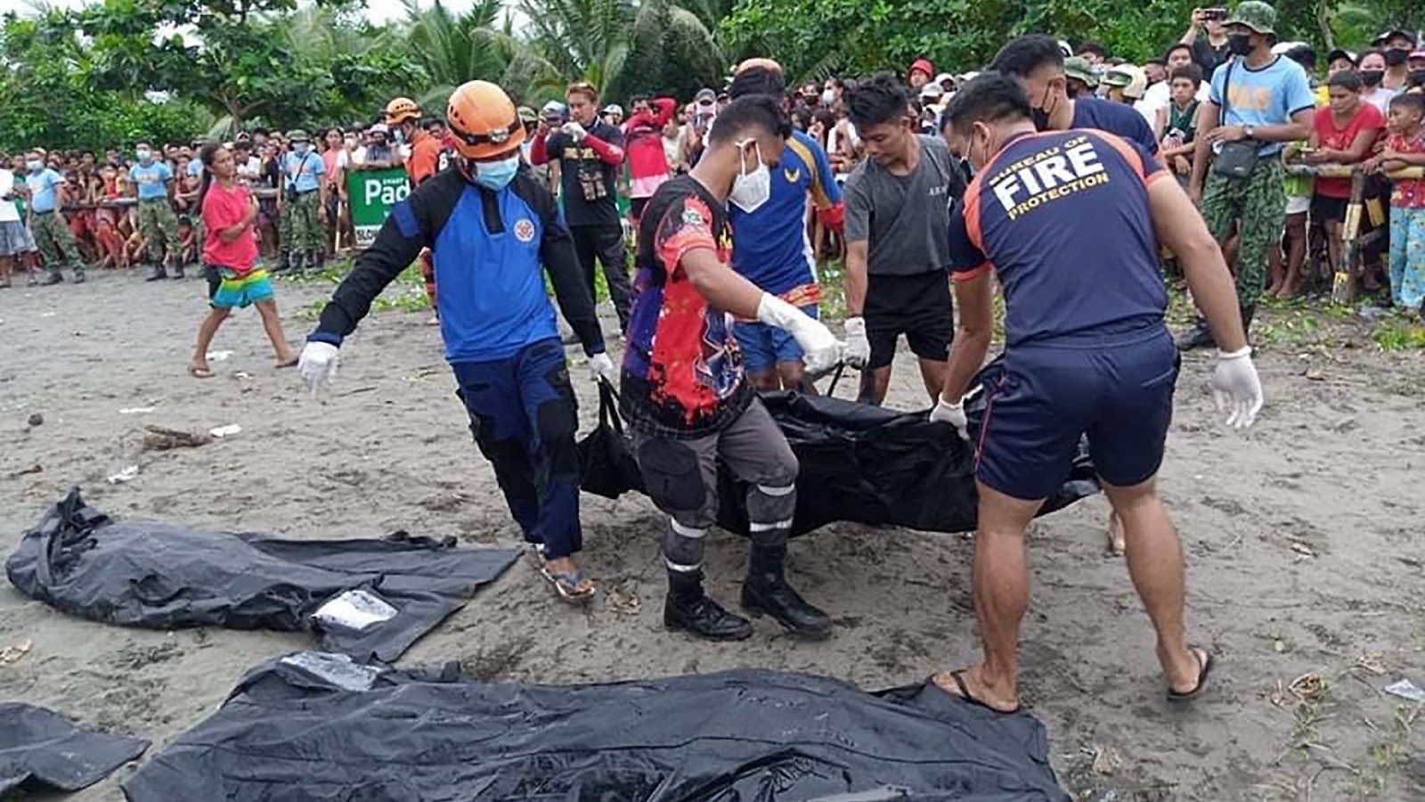 Rescatistas llevan el cadáver de una víctima de un deslizamiento de tierra provocado por la tormenta tropical Megi