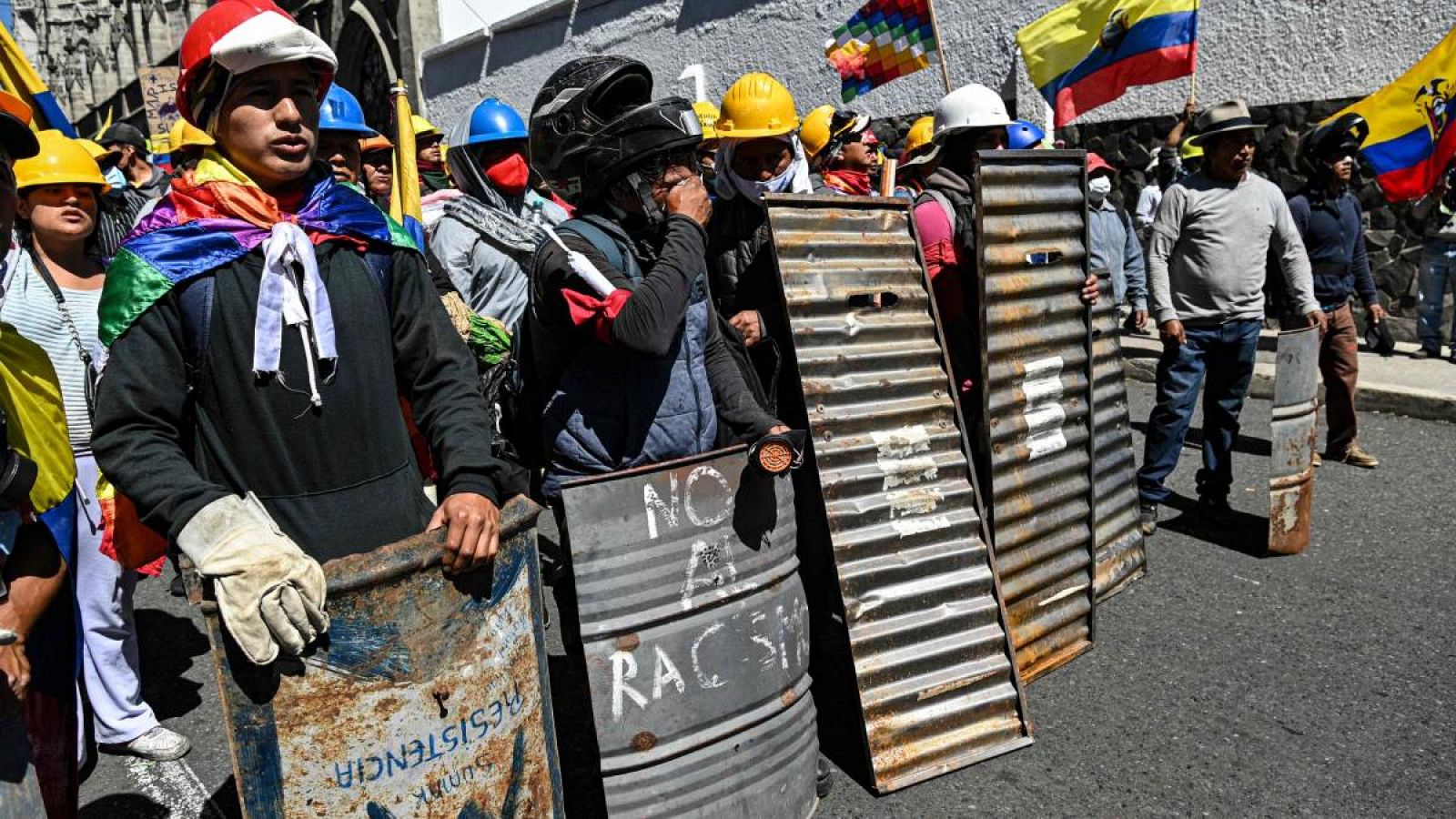 Indígenas con escudos improvisados ¿¿permanecen fuera de la escuela secundaria Matovelle, esperando las resoluciones de los líderes indígenas luego de que el gobierno suspendiera las negociaciones, en Quito.