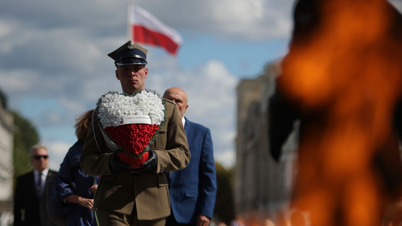Un soldado polaco sostiene una corona de flores mientras asiste a una ceremonia de conmemoración nacional del aniversario de la Segunda Guerra Mundial en Varsovia.