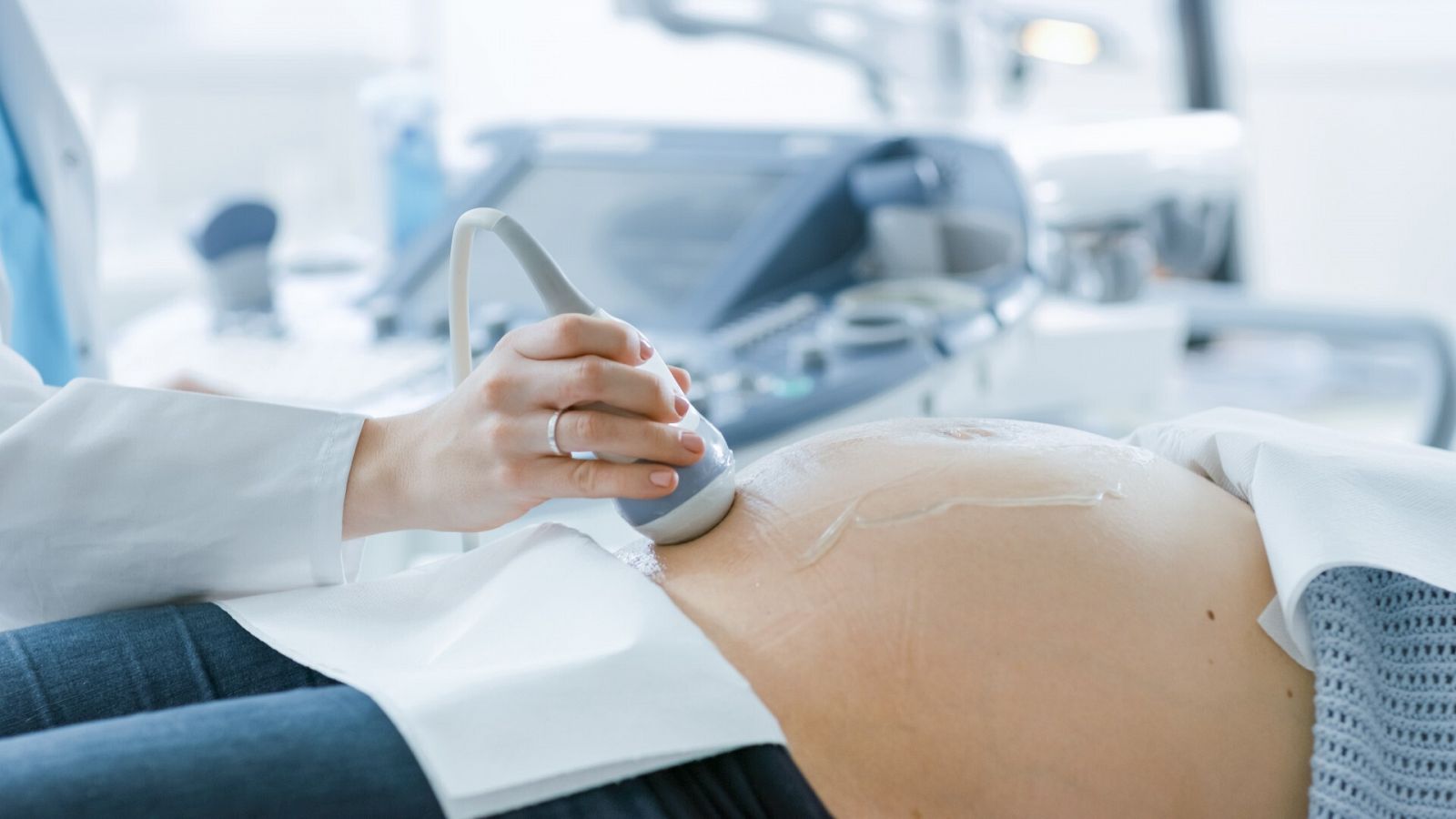 Un médico hace una ecografía a una paciente embarazada
