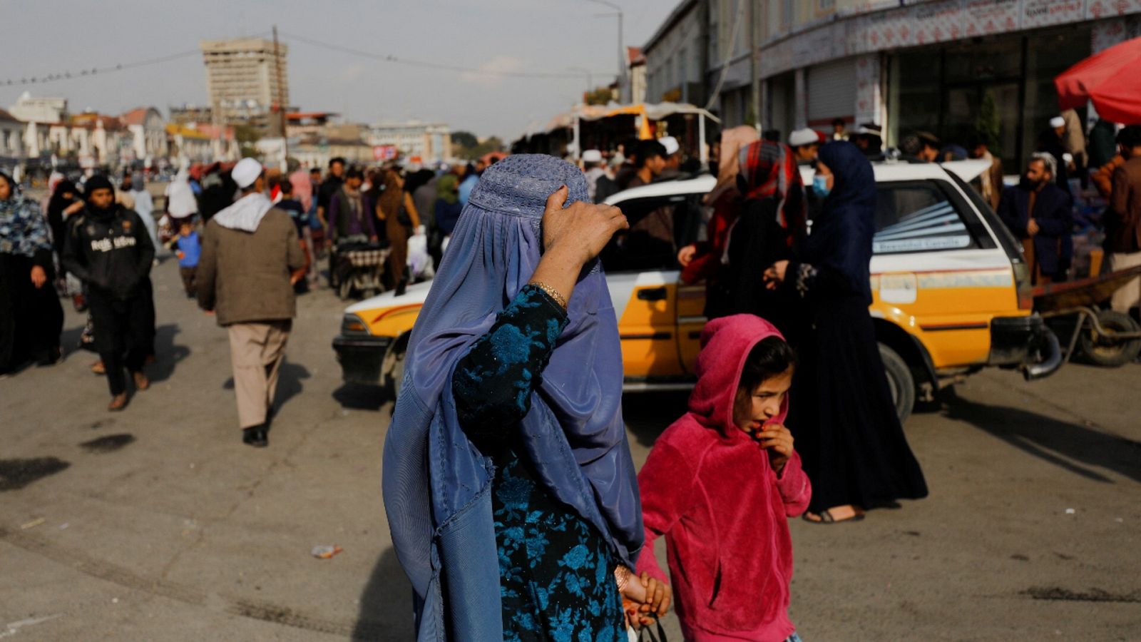 Una mujer y una niña andando por una calle de Kabul, la capital de Afganistán.