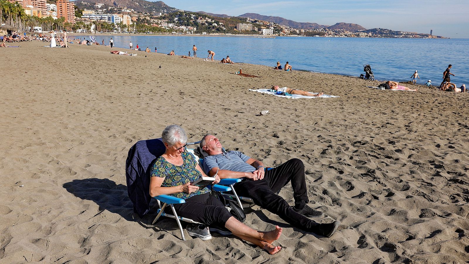 La gente disfruta del tiempo en la playa de la Malagueta durante un día de invierno inusualmente cálido en Málaga